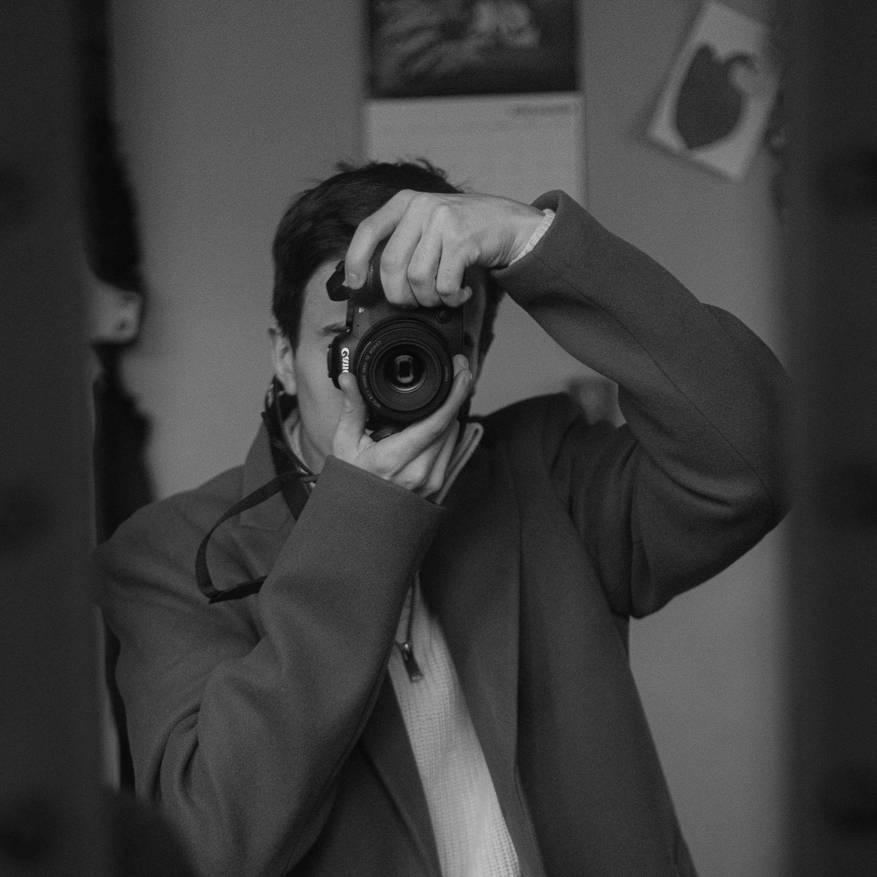 Somone holding a camera up taking a self portrait through a mirror
